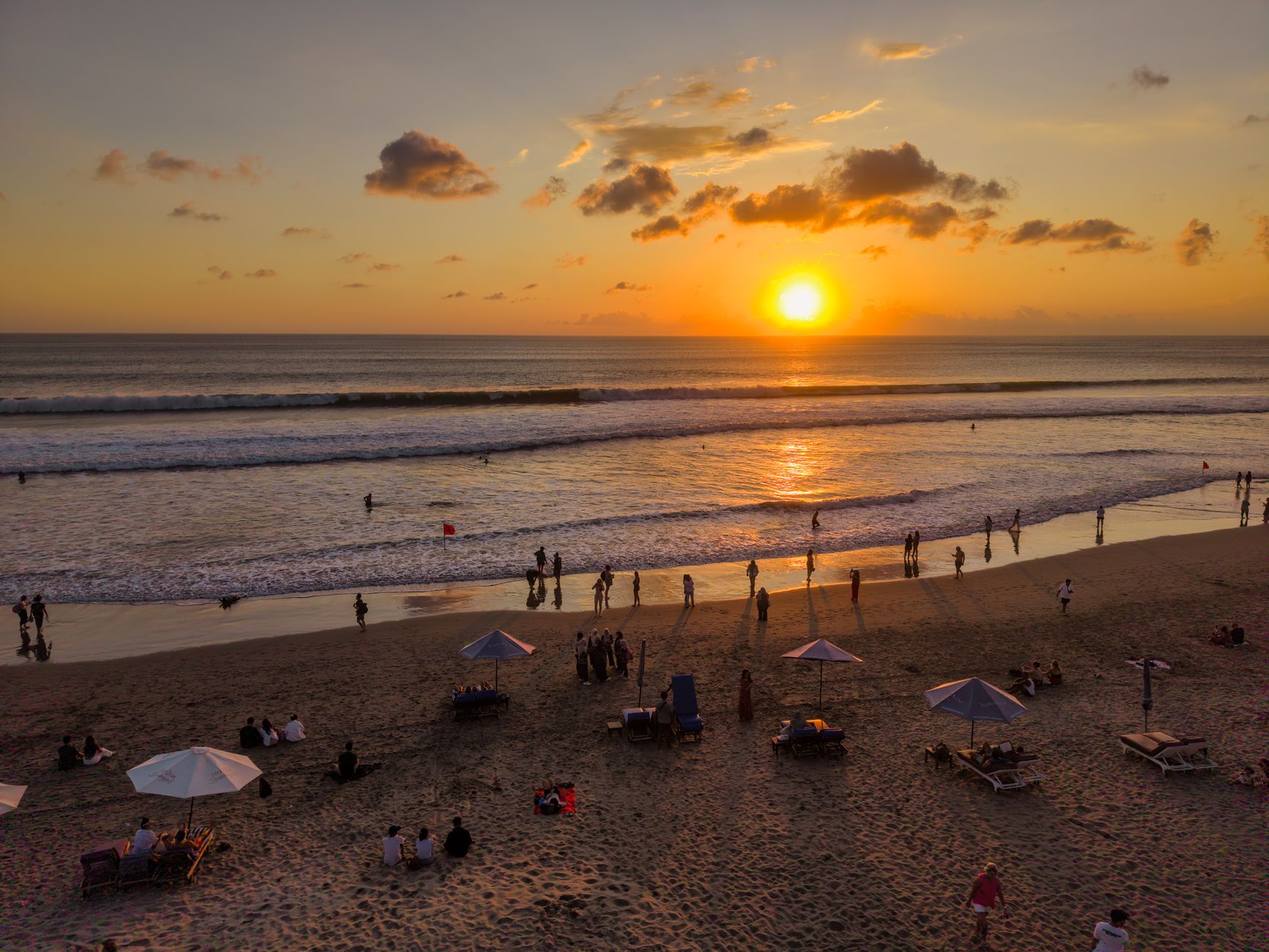 Surfers and sunset crowds on Kuta Beach, Bali
